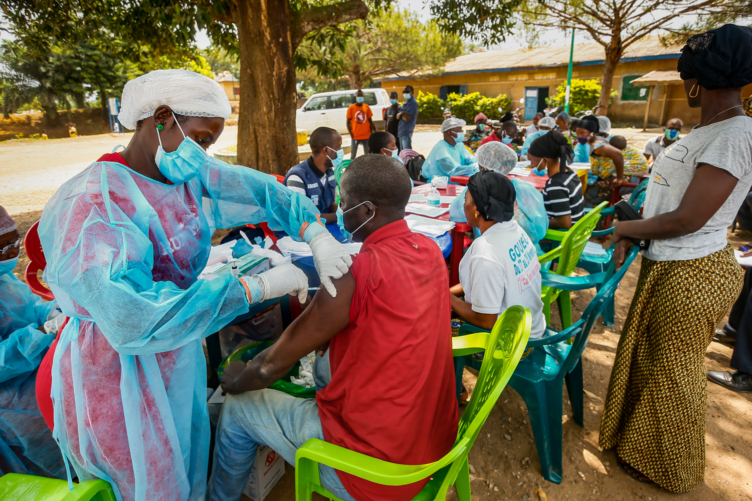 Regional Hospital of NzerekorŽ, health workers administer Ebola.vaccines to members of the GouŽkŽ community.